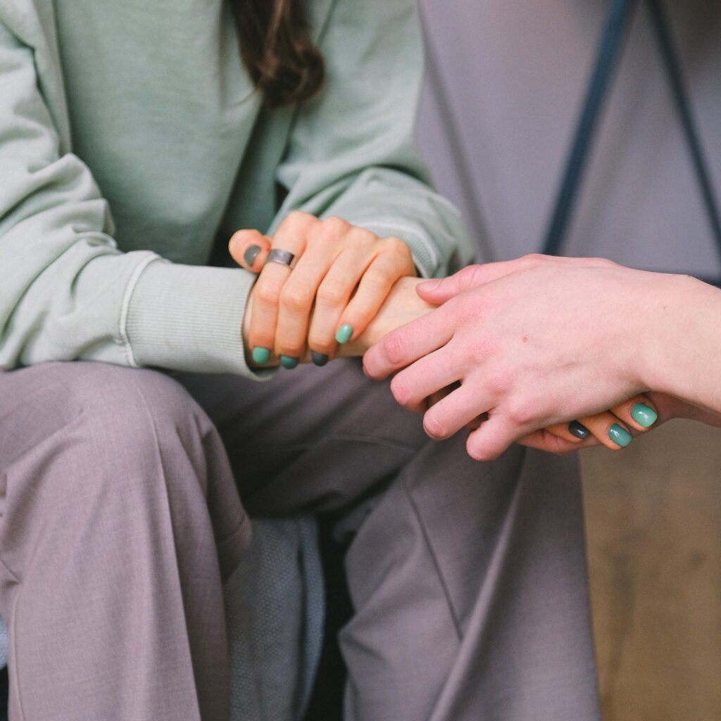 Two people holding hands