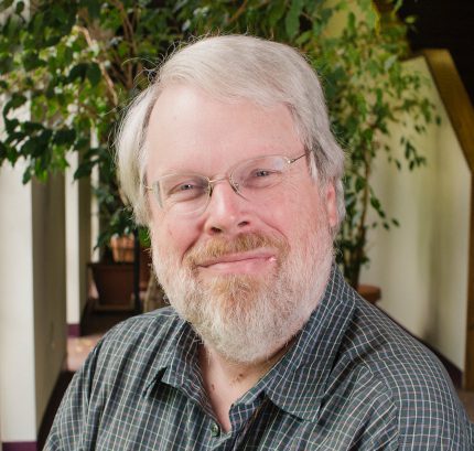 Steve Angell is pictured with plants in the background