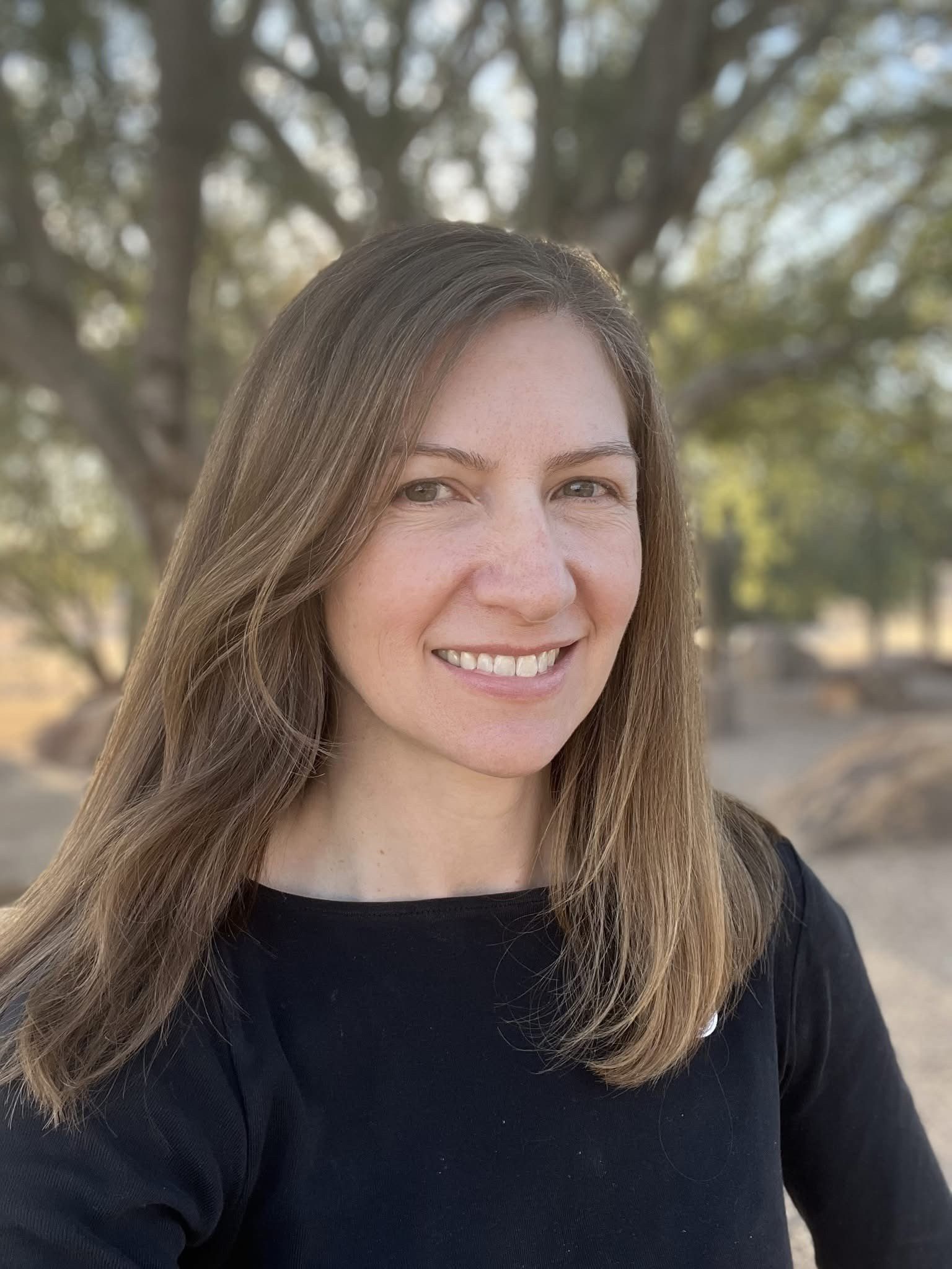 Colleen Wessel-McCoy smiling in front of a tree