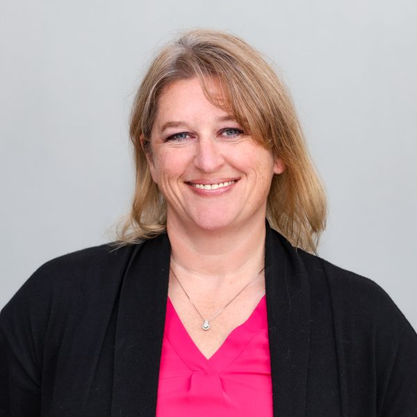 Colleen Wessel-McCoy smiling in front of a tree